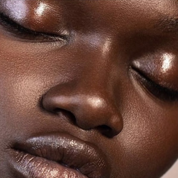 Close up of model face, showcasing a flawless foundation application and a natural glow