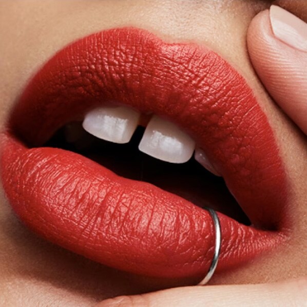 Close up of model lips showcasing a flawless lip colour application, in a striking red colour